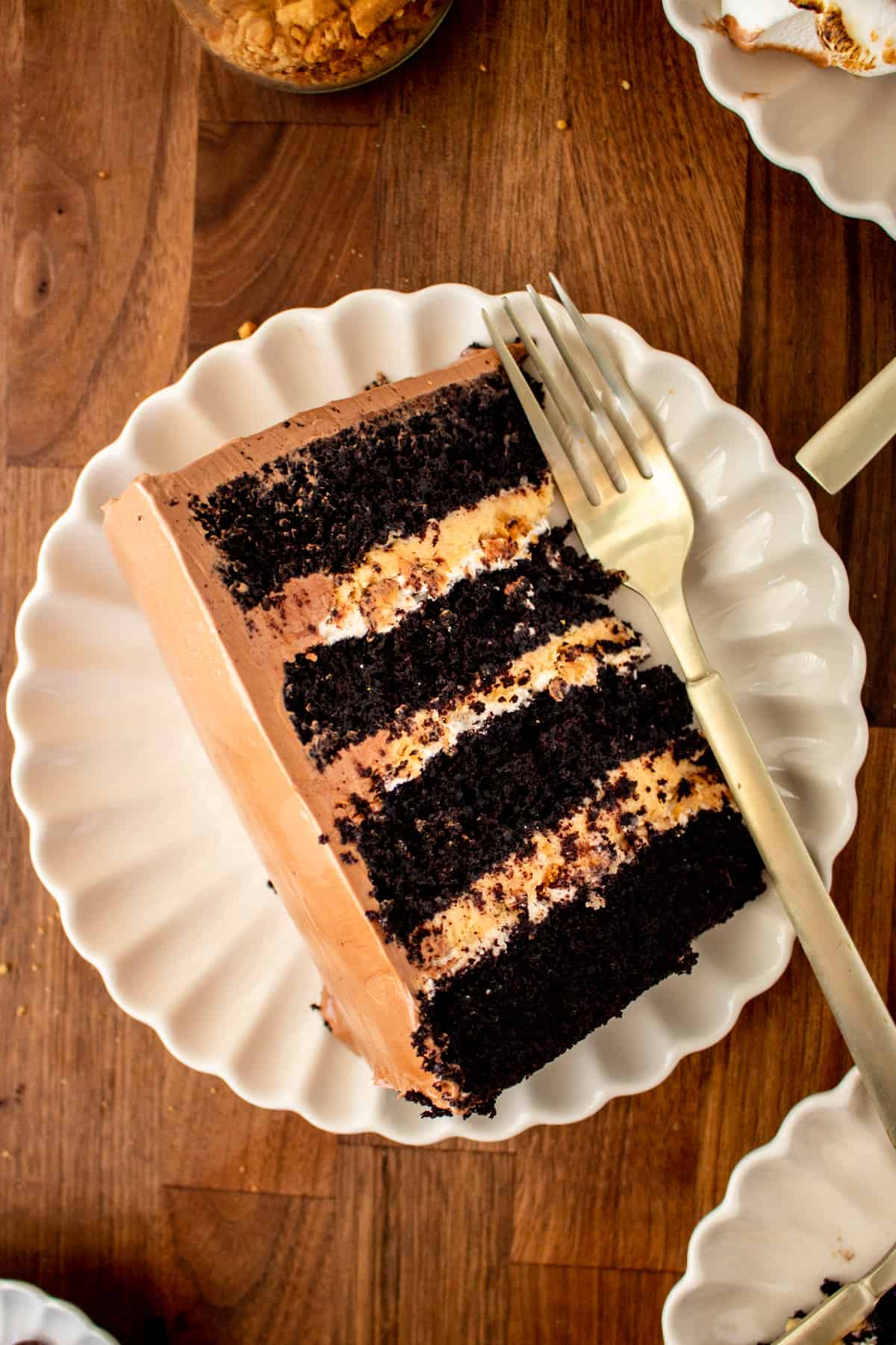 slice of peanut butter smores cake showing the layers of cake and filling