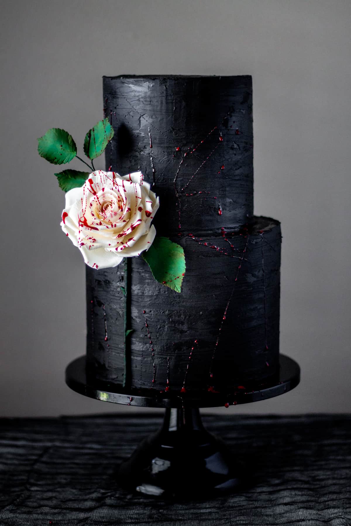 edible fake blood splattered rose and black ganache cake