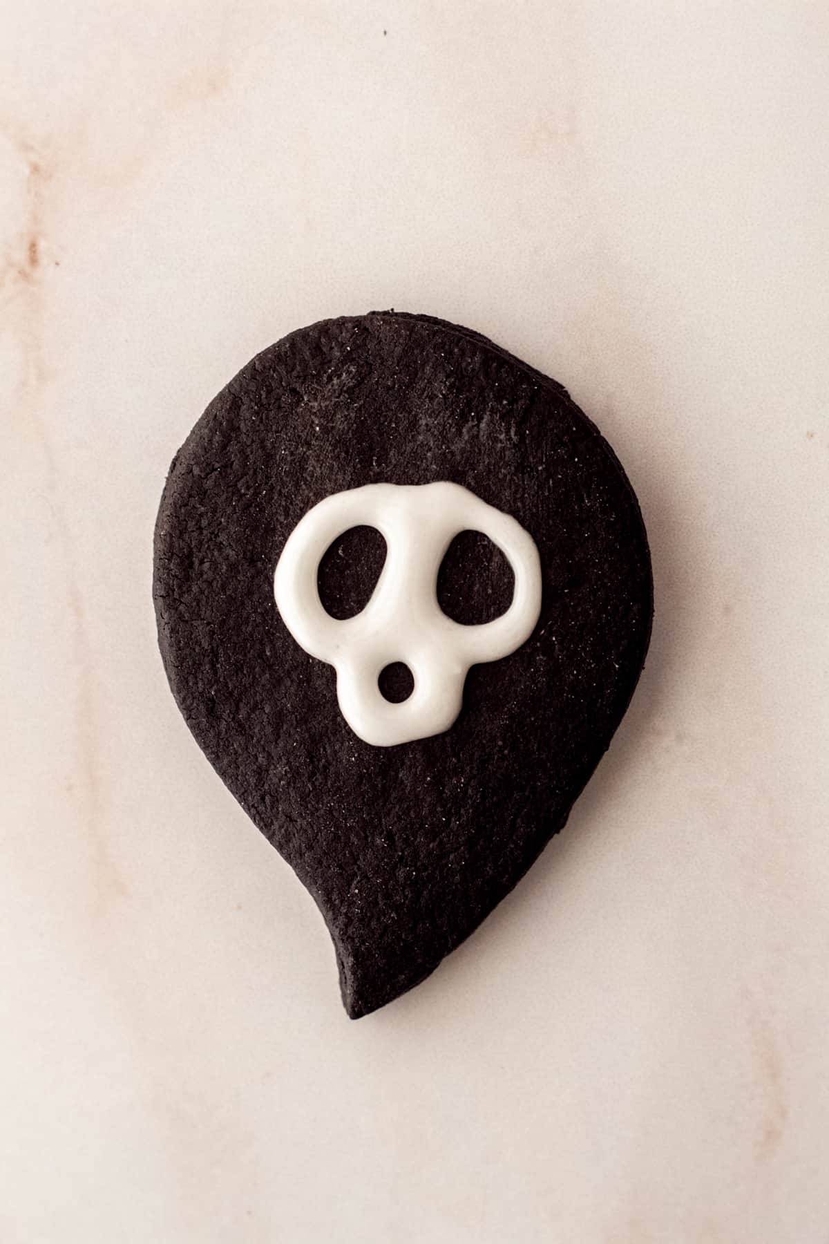black cocoa sugar cookie with royal icing eyes for ghost cookies