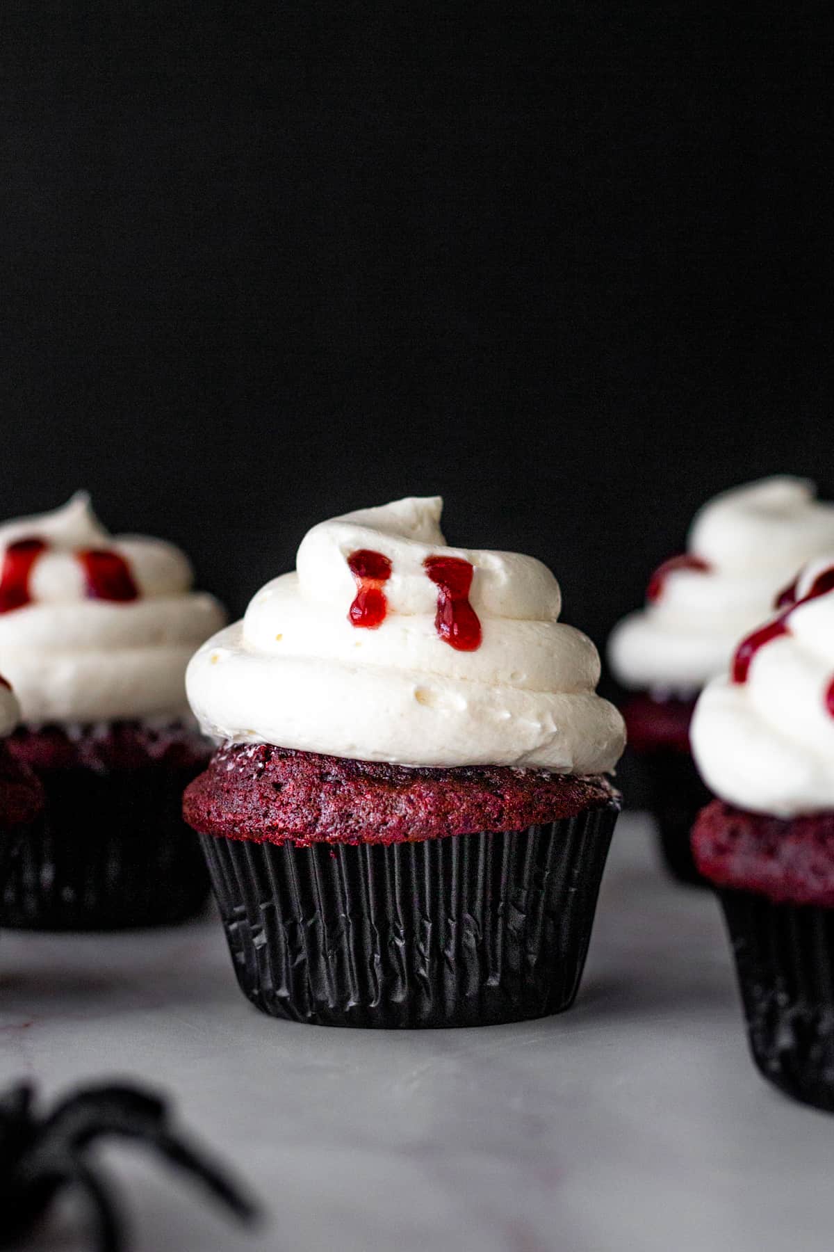 Halloween vampire bite red velvet cupcakes with vanilla ermine frosting