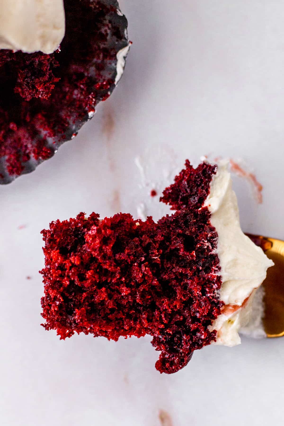 close up of bite of red velvet cupcake on fork