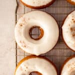maple frosted pumpkin donuts on drying rack