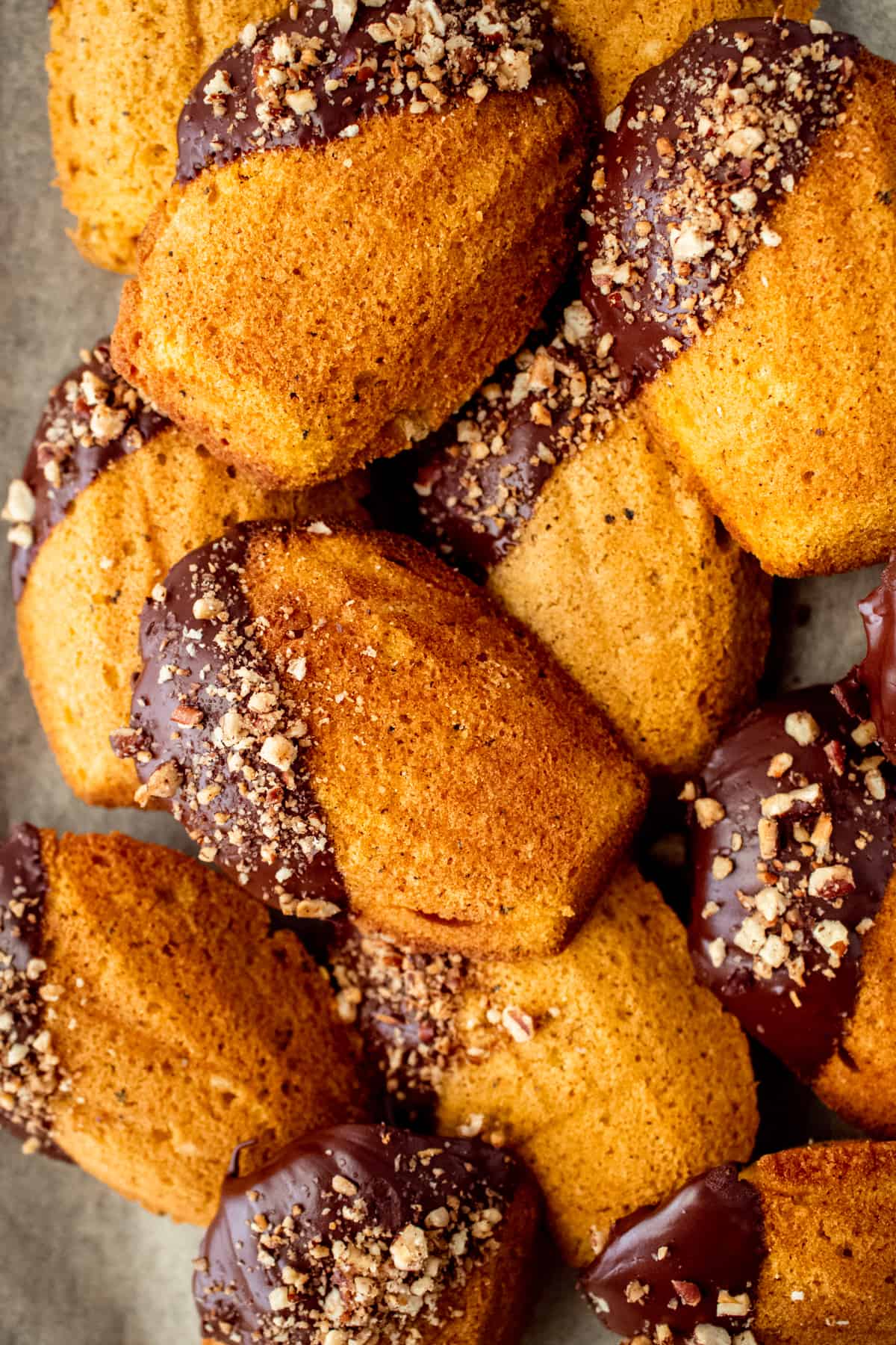 chocolate dipped brown butter pumpkin madeleines piled up