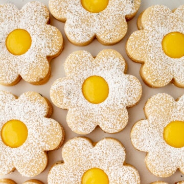 lemon lavender shortbread cookies with lemon curd lined up cookie sheet