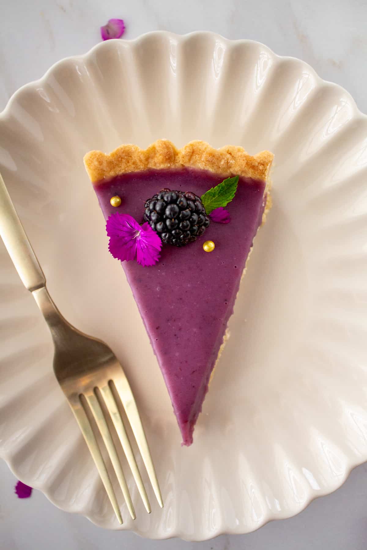 slice of tart on a plate with a fork