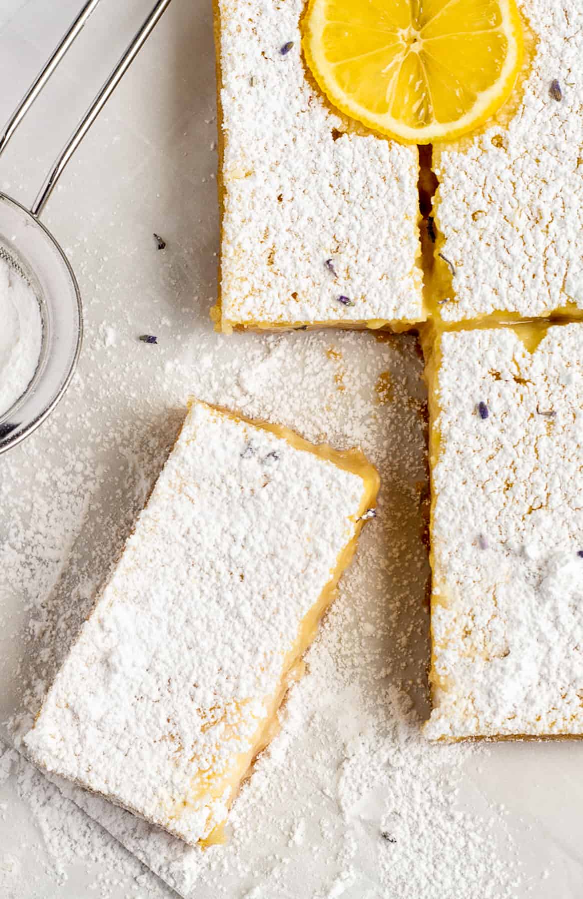 lavender lemon bars sprinkled with confectioners sugar